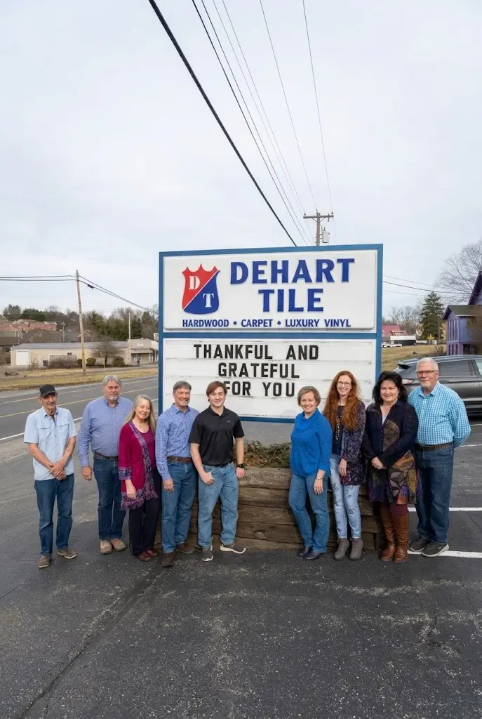 Dehart Tile team posing outside in front of the company sign.
