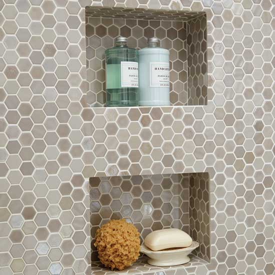Hexagon mosaic tile shower wall with two recessed storage niches.