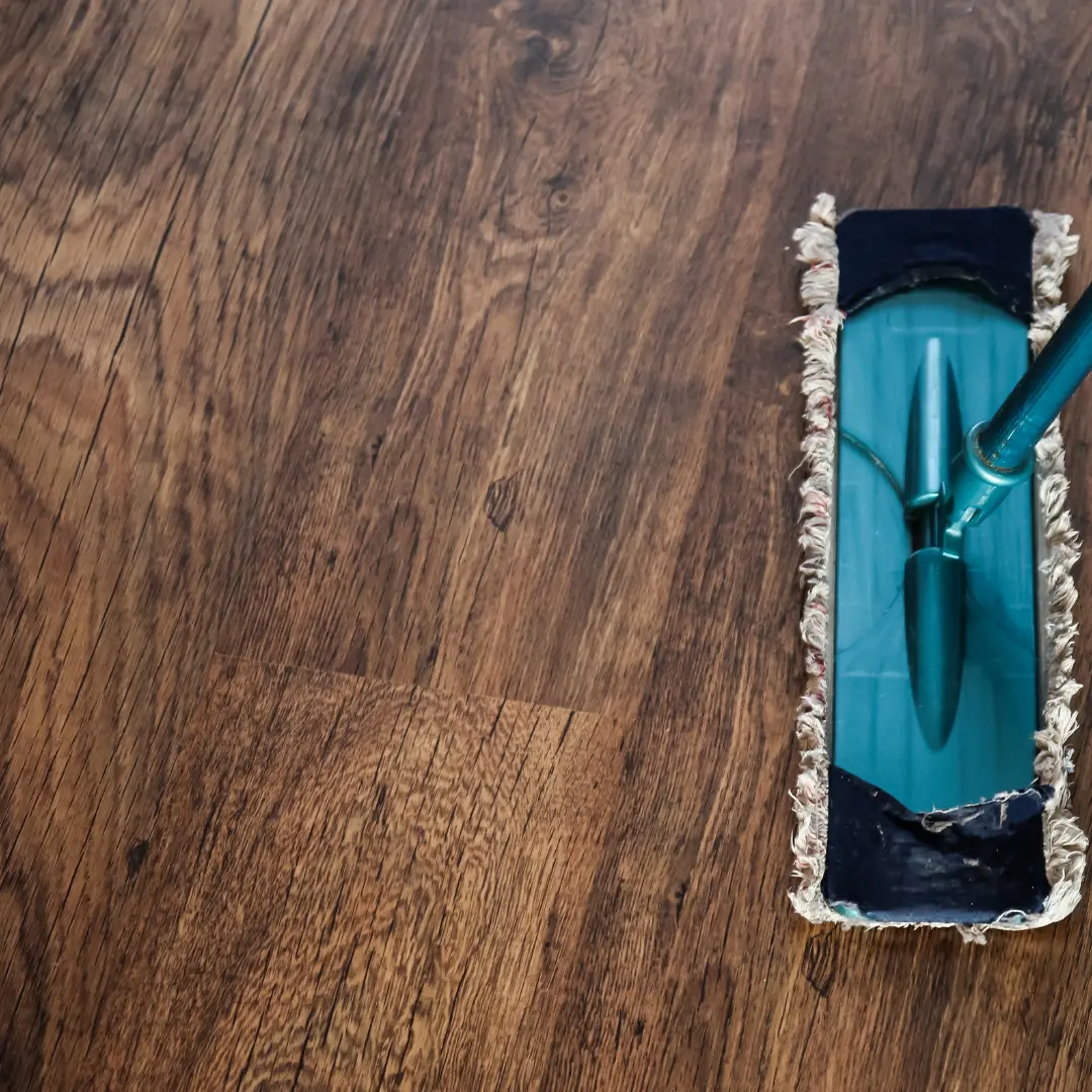 Flat mop cleaning dark wood flooring.