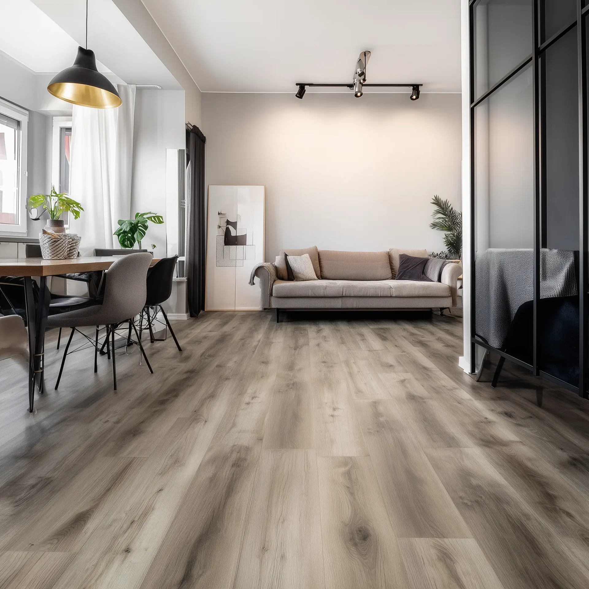 Modern open-concept living room featuring light grey wood-look laminate flooring.