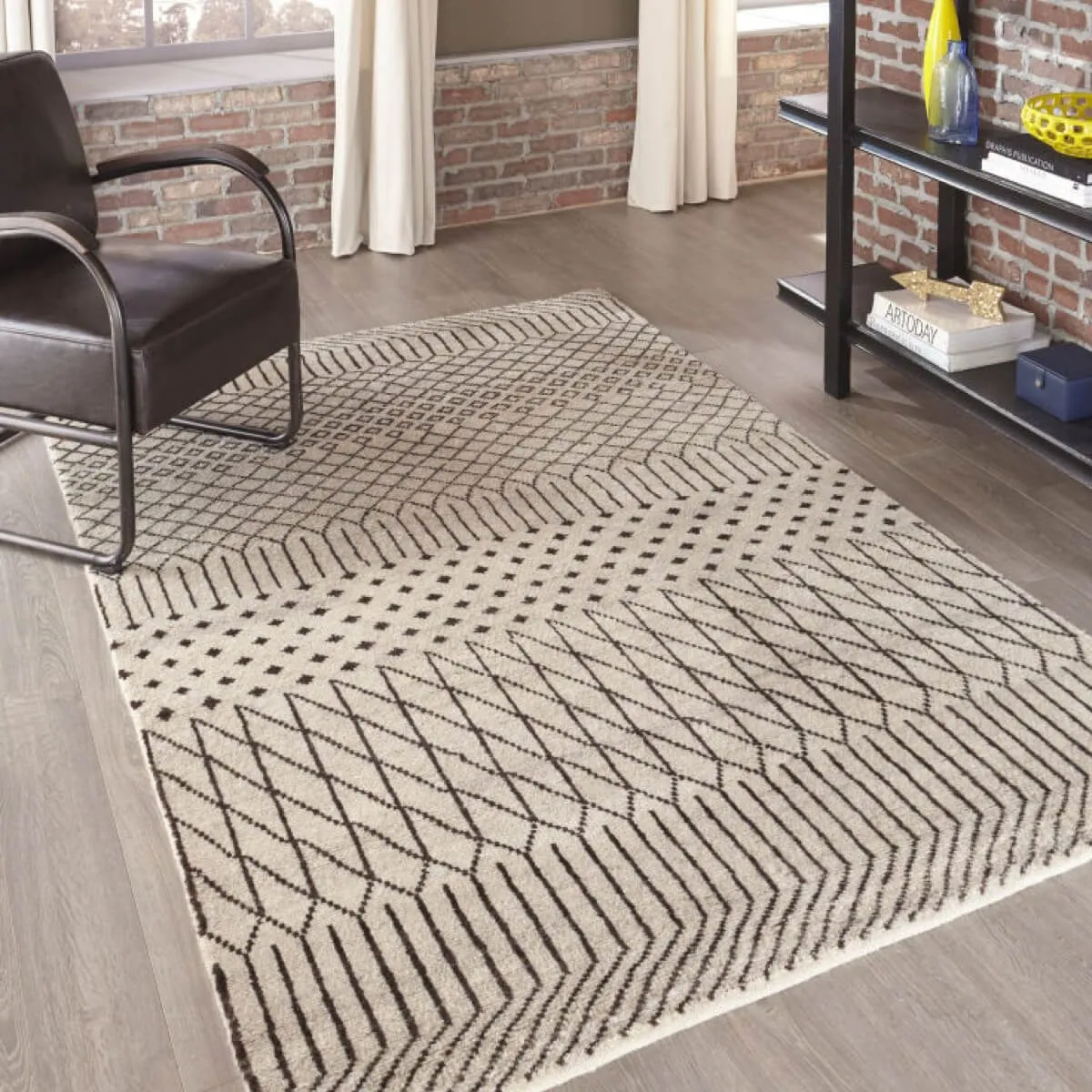 Geometric cream and brown area rug on a hardwood floor.