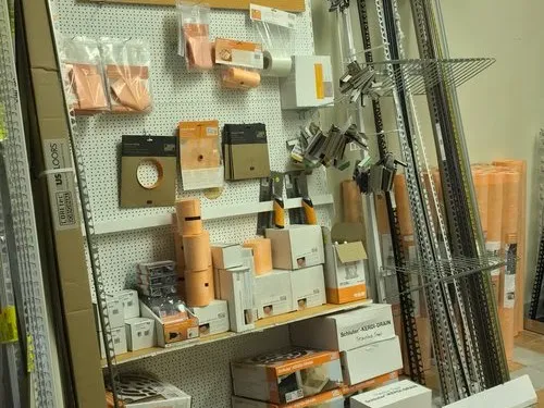 Retail display rack with tile installation tools and supplies.