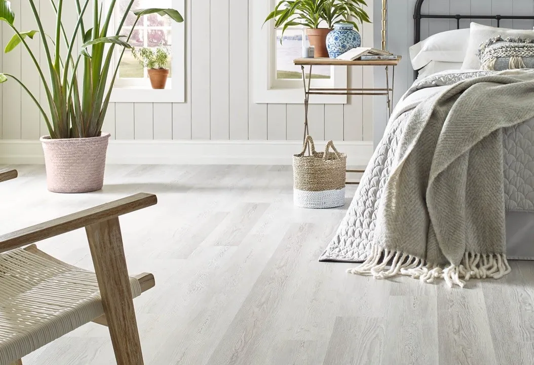 Bright bedroom featuring light-colored wood flooring.
